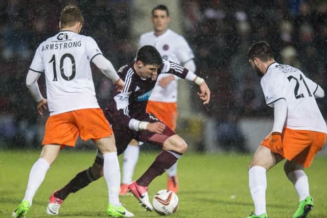 Callum Paterson takes on two Dundee United players. Picture: Ian Georgeson