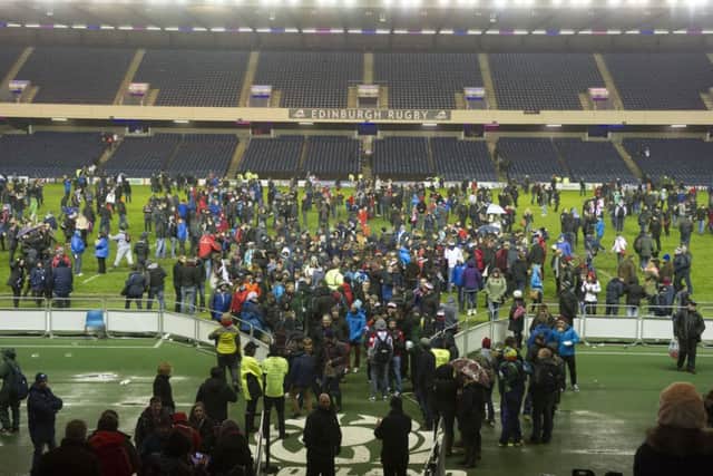 Fans inside Murrayfield step onto the pitch before the stadium closes to be re-surfaced. Picture: SNS/SRU
