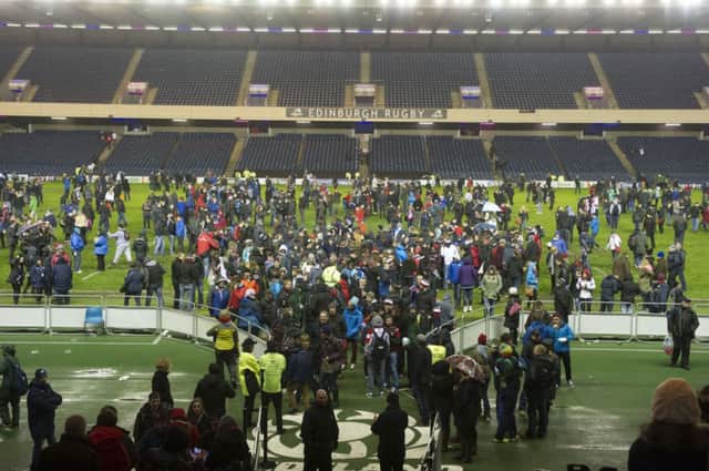 Fans inside Murrayfield step onto the pitch before the stadium closes to be re-surfaced. Picture: SNS/SRU
