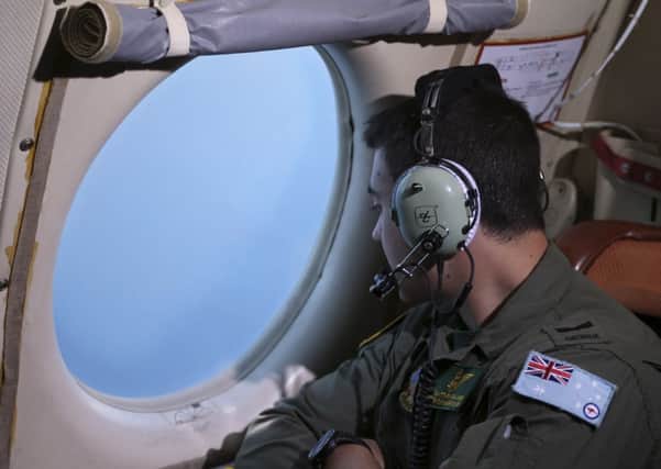 Matthew Falanga of the RAAF scans for debris or wreckage of the missing flight in the Southern Indian Ocean. Picture: Getty