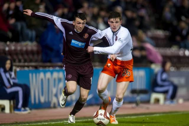 David Smith tussles with Dundee Uniteds John Rankin at Tynecastle on Friday evening. Photograph: SNS
