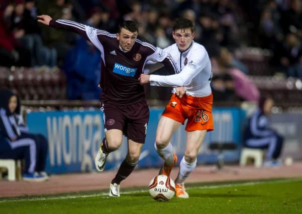 David Smith tussles with Dundee Uniteds John Rankin at Tynecastle on Friday evening. Photograph: SNS