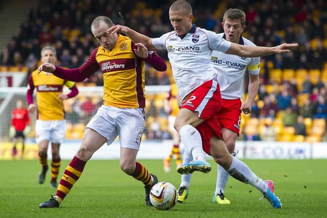 James McFadden, left, tangles with County defender Erik Cikos. Picture: SNS
