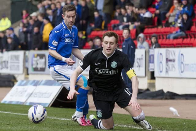 Scorer of Saints' first goal Steven MacLean clashes with Hibernian's Liam Craig. Picture: SNS