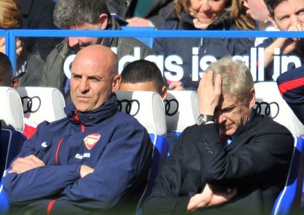 Arsene Wenger can't bear to look as Chelsea demolish Arsenal 6-0 at Stamford Bridge. Picture: AFP/Getty