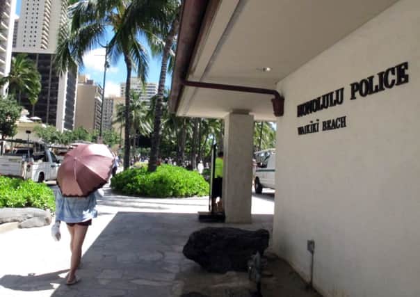 A pedestrian walks in front of a Honolulu Police Department station in Honolulu's tourist area of Waikiki. Picture: AP