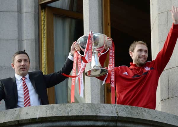 Aberdeen manager Derek McInnes (left) and captain Russell Anderson hold aloft the trophy. Picture: SNS
