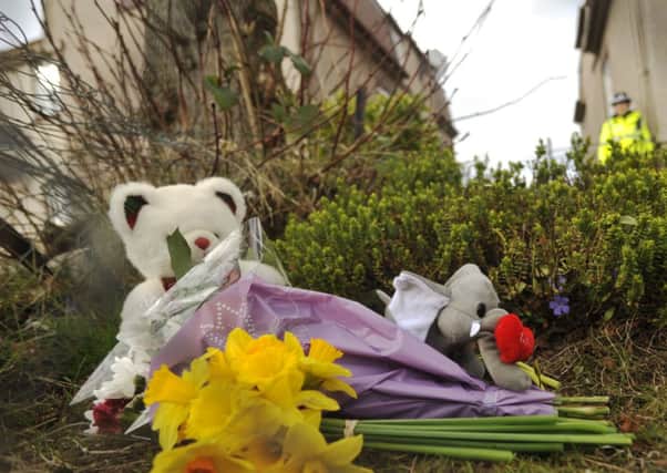 Childrens toys and flowers left outside the flat in Thornton, Fife. Pictures: Phil Wilkinson