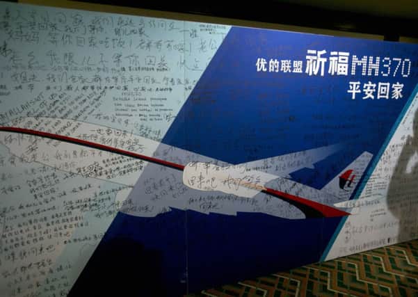 Prayers and messages of support written on a billboard at a Beijing hotel housing relatives of those on-board flight MH370. Picture: AP