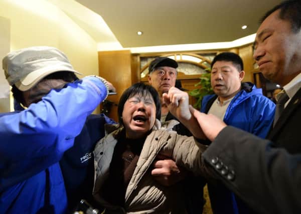 Angry relatives of missing passengers on Malaysia Airlines flight MH370 weep after hearing the news that the plane plunged into Indian Ocean at a hotel in Beijing. Picture: Getty