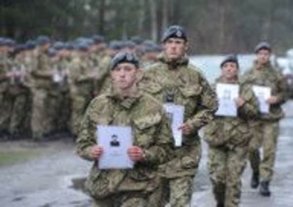 RAF personnel carry pictures of each of the 50 men killed by the Gestapo. Picture: Contributed