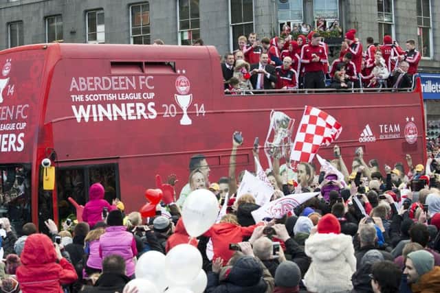 Aberdeen fans surround the open top bus as the team celebrate their Scottish League Cup triumph in style. Picture: SNS