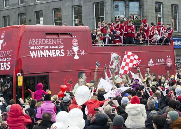 Aberdeen fans surround the open top bus as the team celebrate their Scottish League Cup triumph in style. Picture: SNS