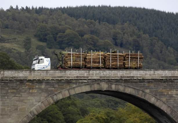 A timber lorry travels over the bridge over the Tay at Dunkeld, Perthshire. Picture: TSPL