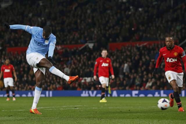 Manchester City's Yaya Toure (L) scores against Manchester United. Picture: Reuters