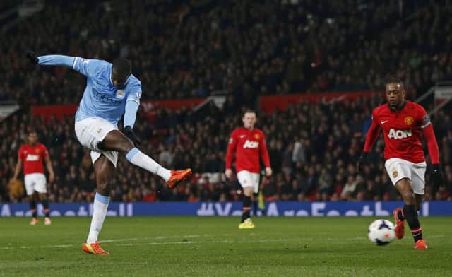 Manchester City's Yaya Toure (L) scores against Manchester United. Picture: Reuters