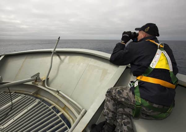 An Australian ship looks for any possible debris from the plane, which is lost presumed crashed. Picture: AP