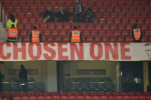 Stewards stand by the banner depicting Manchester United manager David Moyes. Picture: Getty
