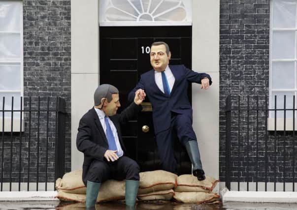 Greenpeace protesters posing as Nick Clegg and David Cameron at Old Palace Yard in London. Picture: LNP