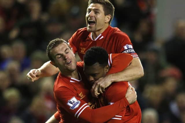 Daniel Sturridge with Steven Gerrard, top, and Jordan Henderson, left after his strike. Picture: Reuters
