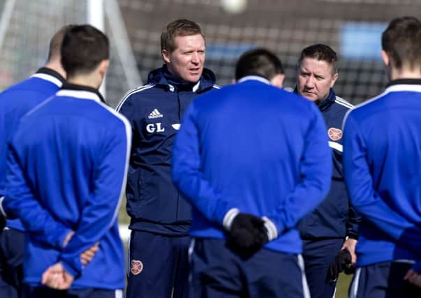 Hearts manager Gary Locke speaks to his players during training. Picture: SNS