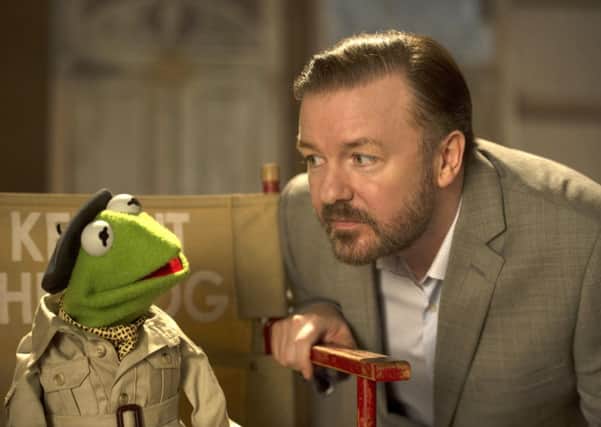 Kermit, left, and Ricky Gervais in a scene from "Muppets Most Wanted." Picture: AP