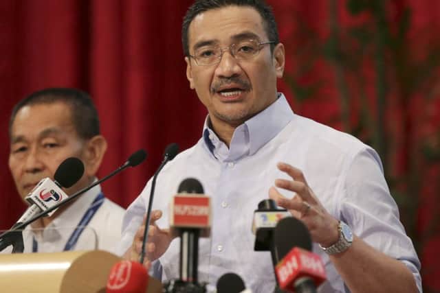 Malaysia's acting Transport Minister Hishammuddin Hussein, right, addresses the media. Picture: AP
