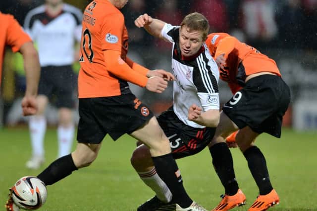 Aberdeens Barry Robson tussles with Dundee United during their New Years Day clash. Picture:SNS