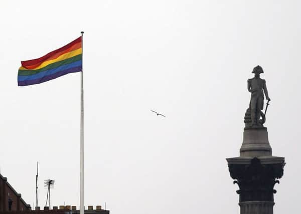 A rainbow flag flies over a building next to Nelson's Column monument in Trafalgar Square, central London. Picture: AP