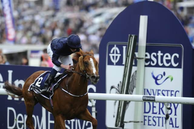 Ryan Moore rides Ruler of the World to victory in the Investec Derby at Epsom last year. Picture: Getty