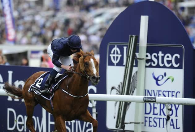 Ryan Moore rides Ruler of the World to victory in the Investec Derby at Epsom last year. Picture: Getty