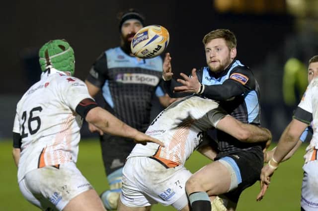 Ospreys' Justin Tipuric (centre) tackles Finn Russell. Picture: SNS