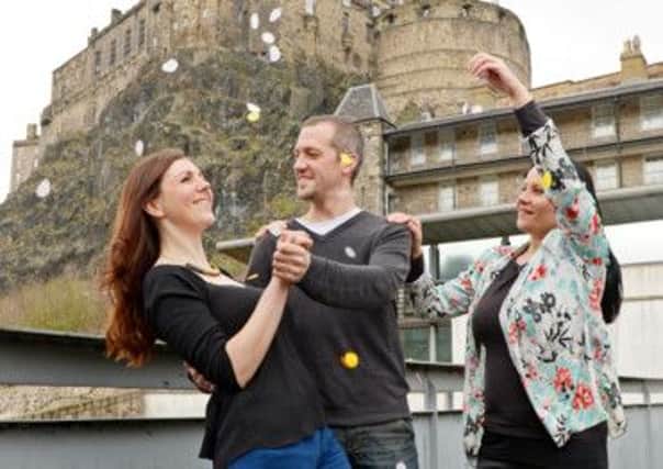 Dance teacher Dawn-Claire Robertson sprinkles confetti over Carrie Shepherd and Phil Mansfield on the roof terrace of Dance Base. Picture: Phil Wilkinson