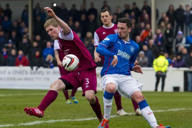 Arbroath's Colin Hamilton (left) goes up against Rangers striker Nicky Clark. Picture: SNS
