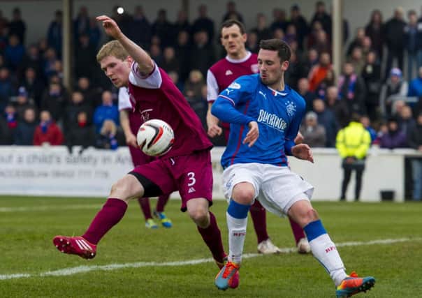 Arbroath's Colin Hamilton (left) goes up against Rangers striker Nicky Clark. Picture: SNS