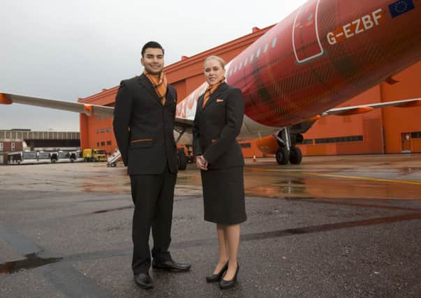 Cabin crew sport the new easyJet tartan in front of a plane named Inverness. Picture: Tim Anderson
