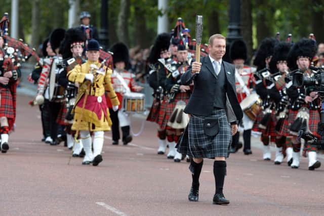 Sir Chris Hoy carries the baton in London last October. Picture: PA