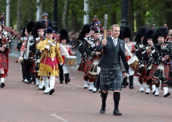 Sir Chris Hoy carries the baton in London last October. Picture: PA