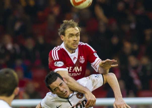 Aberdeen captain Russell Anderson wins an aerial duel with with Brian Graham.  Picture: SNS