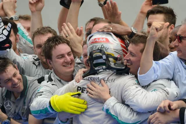 Lewis Hamilton celebrates in Malaysia with his teammates. Picture: AFP