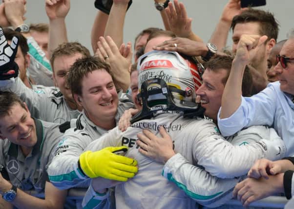 Lewis Hamilton celebrates in Malaysia with his teammates. Picture: AFP