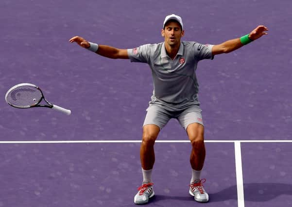 Novak Djokovic drops his racket in celebration. Picture: Getty