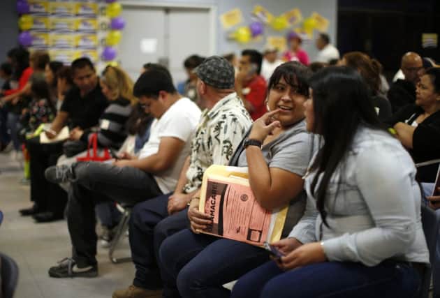 People wait to sign up at an enrolment event in Cudahy, California. Picture: Lucy Nicholson/Reuters