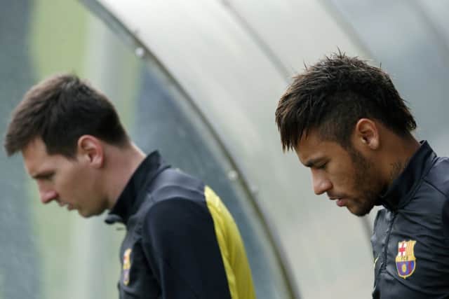 Lionel Messi, left, and Neymar during training yesterday ahead of tonights clash with Atletico Madrid. Picture: Reuters