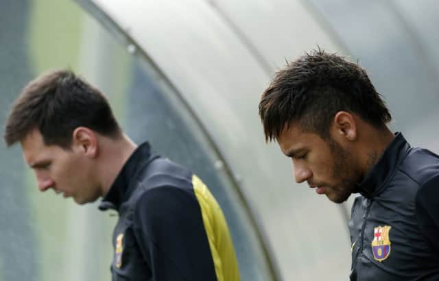 Lionel Messi, left, and Neymar during training yesterday ahead of tonights clash with Atletico Madrid. Picture: Reuters