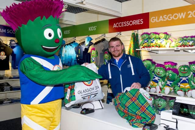 Commonwealth Games silver medalist Peter Kirkbride is all smiles as he and mascot Clyde open the first official Glasgow 2014 retail outlet in the city's Central Station. Picture: SNS