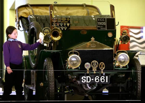Bella Morgan, 7, from Whitburn polishes the world's second oldest Rolls-Royce at the Riverside Museum in Glasgow. Picture: PA