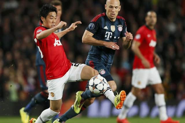 Manchester United's Shinji Kagawa fights for the ball with Bayern Munich's Arjen Robben. Picture: Reuters