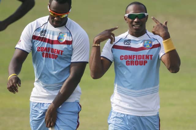 Dwayne Bravo, right, gestures to his teammates during a training session in Dhaka. Picture: Aijaz Rahi/AP