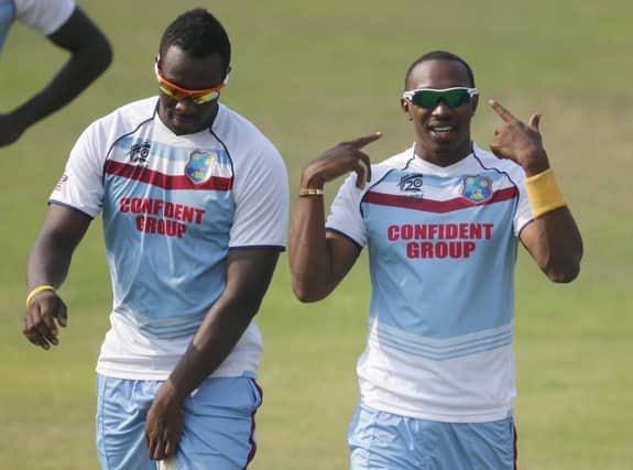 Dwayne Bravo, right, gestures to his teammates during a training session in Dhaka. Picture: Aijaz Rahi/AP